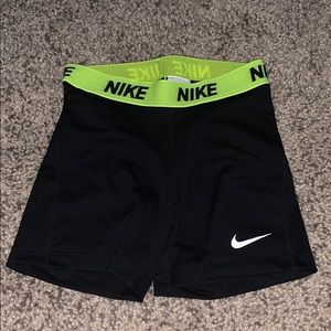 Black Nike Pros with neon yellow waste band.